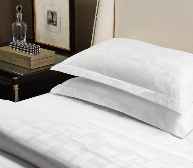 This is an image of the Braque top cover and pillow shams on a boutique hotel bed.