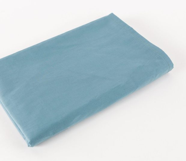 Standard Supreme Vat-Dyed Sheeting for healthcare bedding for hospitals and health systems. Shown folded and in the color Ceil Blue.