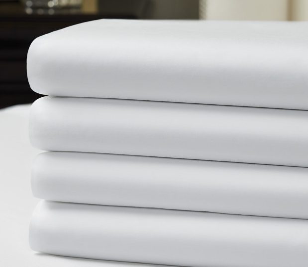 Image is of a stack of luxury hotel sheets. These quality sheets are the Vidori line.