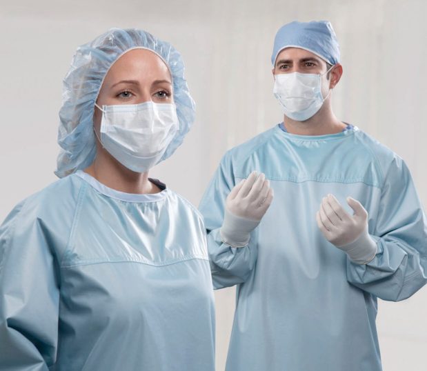 Two surgeons wear reusable SurgiTex surgical gowns.