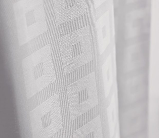 This block-on-block decorative top cover adds elegance without the hassle of duvet inserts. Image shows a detailed close up of a block on block top cover.