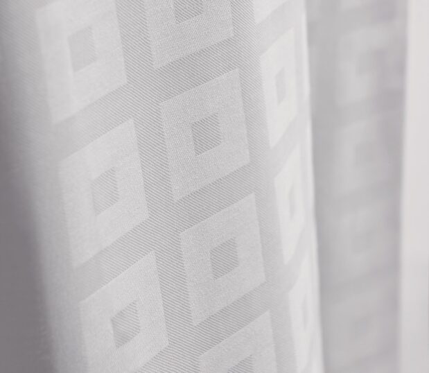 This block-on-block decorative top cover adds elegance without the hassle of duvet inserts. Image shows a detailed close up of a block on block top cover.