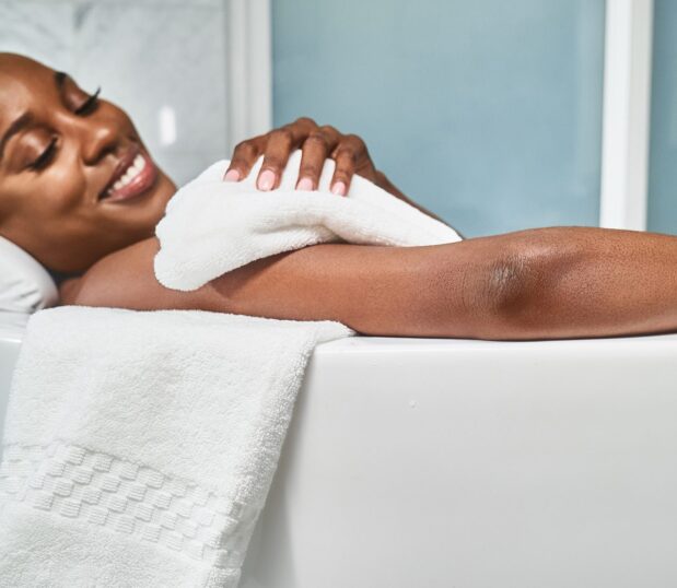 A favorite of a former US President, these luxury bath towels made in America will impress five-star guests and dignitaries alike. Shown here: a model in a tub using capitol towels.