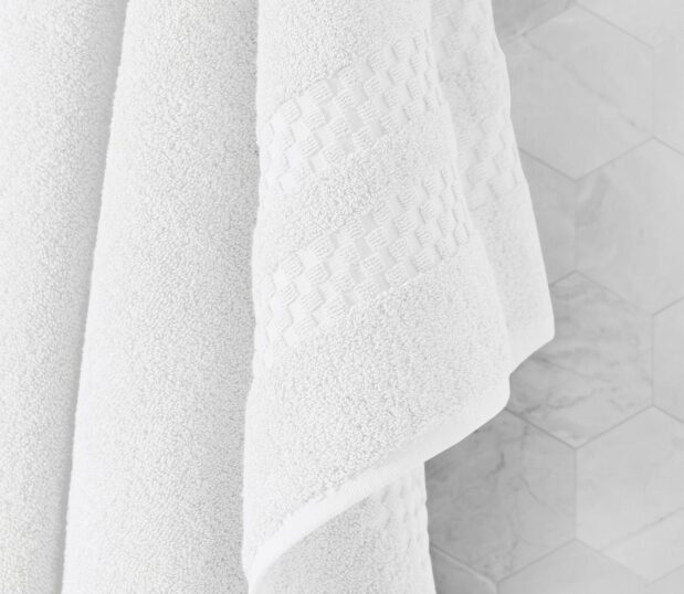 A favorite of a former US President, these luxury bath towels made in America will impress five-star guests and dignitaries alike. Try them today! Image shows a detail shot of the decorative dobby border of the capitol collection bath towel.