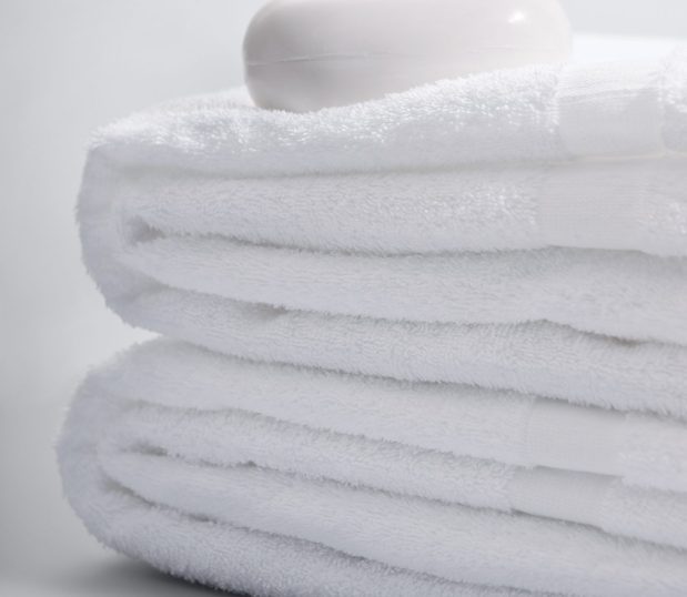 Detail of a stack of Classic Room Ready affordable hotel towels. These are value, pre-washed towels.