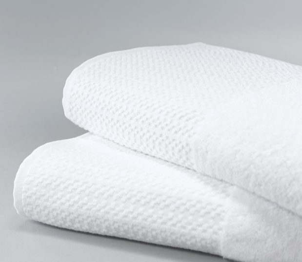Stack of two white Elevations towels.