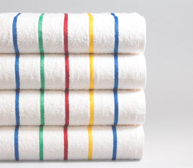 Set of four Festival striped pool towels. The towels have blue, yellow, red and green stripes.