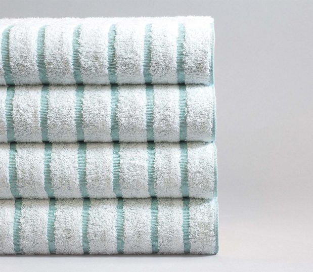 Stack of four teal striped pool towels. Pool towels need to be quality towels to withstand