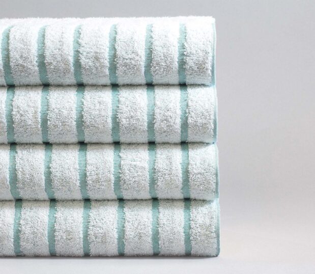 Stack of four teal striped pool towels. Pool towels need to be quality towels to withstand