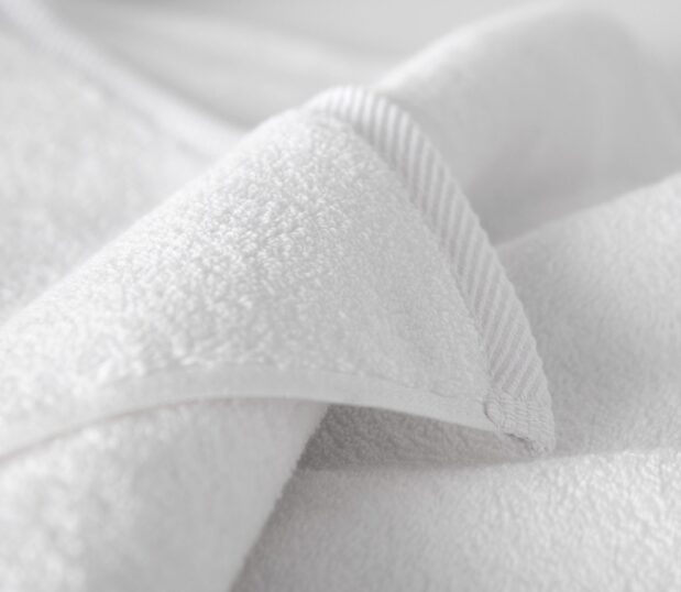 Image shows a detail shot of a Vidori towel and the decorative hem border.