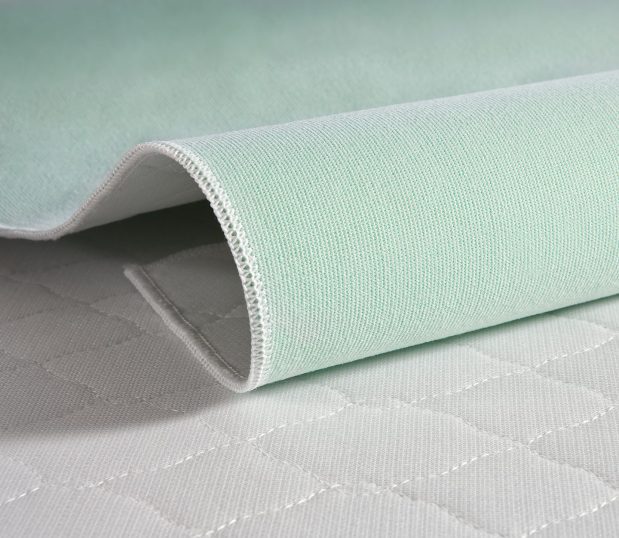 TruVal® Underpads are made from 100% synthetic materials, giving them superior durability. Laminated construction extends service life even further. Close up of scalloped diamond quilting pattern featured.