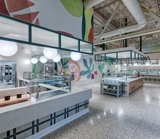 A different angle showing custom wallcovering in a cafe showing fruit and vegetable graphics.