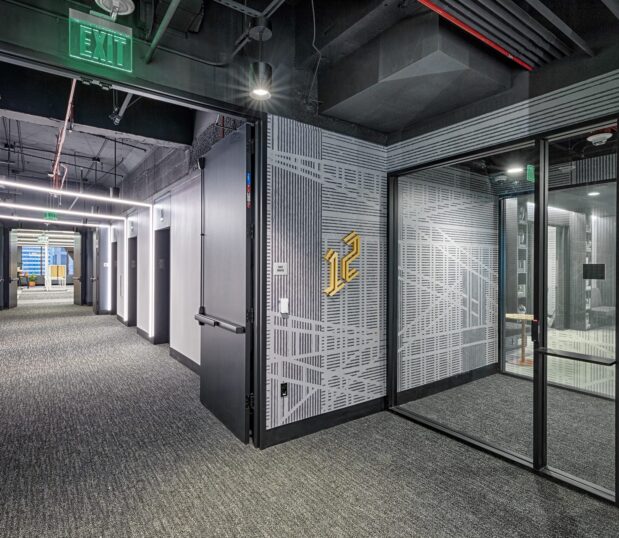 Office hallway with custom wallcovering with black and white graphics.