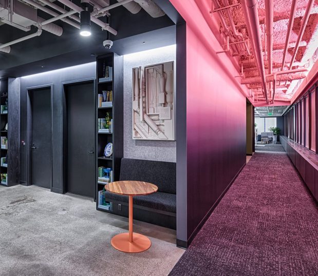 Work space with custom wallcovering in the hallway with a gradient from Hot Pink to Purple.