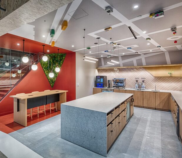 Break area with custom wallcovering on the ceiling made to look like a road with toy cars and trucks driving on it.