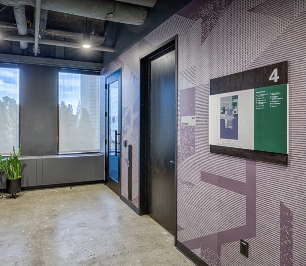 Hallway with plum colored custom wallcovering with strong textural graphics.