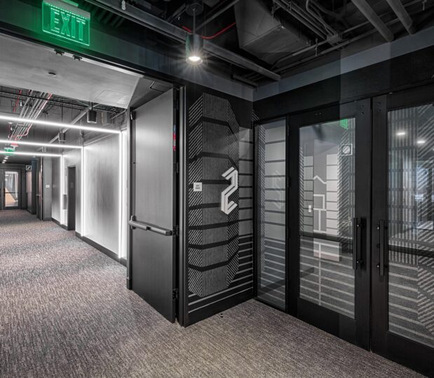 Hallway with custom wallcovering with grey and black graphics and 3 dimensional numbers to show the floor number.