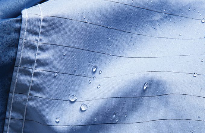 Close up of compel fabric with droplets of water.
