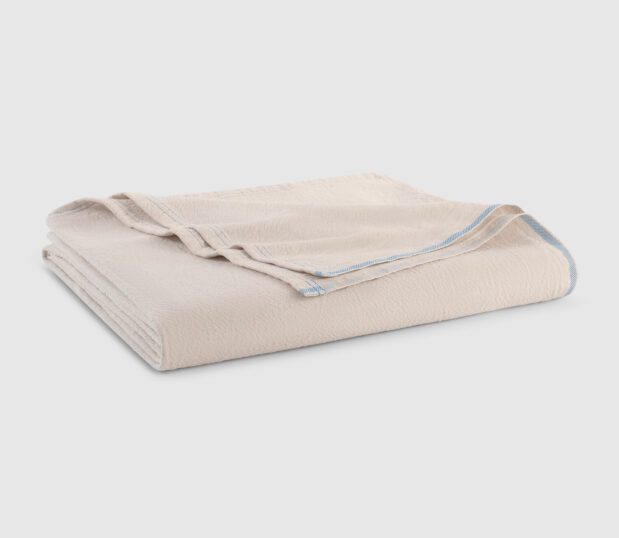 Our lightweight DuroSoft Bath Blanket is a 100% cotton bath blanket and it's color is natural. Shown folded here in this image.