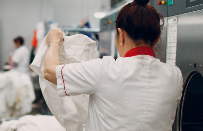 A woman inspects laundry in a hotel